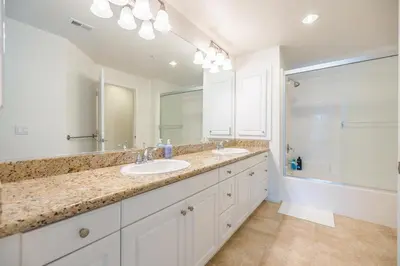 a bathroom with two sinks and a large mirror at Luxury Irvine Spectrum 2 bedrooms 2 Bathrooms Kitchen pool Apartment in Irvine