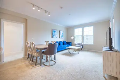 a living room with a table and a blue couch at Luxury Irvine Spectrum 2 bedrooms 2 Bathrooms Kitchen pool Apartment in Irvine