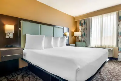 a large white bed in a hotel room at Best Western Plus Oceanside Palms in Oceanside