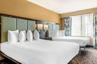 a hotel room with two beds with white pillows at Best Western Plus Oceanside Palms in Oceanside