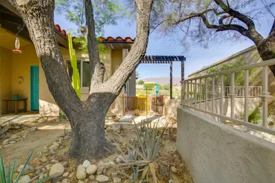 a tree in front of a house with a fence at Roadrunner Roost at Rams Hill Golf Resort! in Borrego Springs