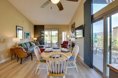 a dining room and living room with a table and chairs at Roadrunner Roost at Rams Hill Golf Resort! in Borrego Springs