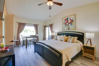 a bedroom with a large bed and a table at Roadrunner Roost at Rams Hill Golf Resort! in Borrego Springs
