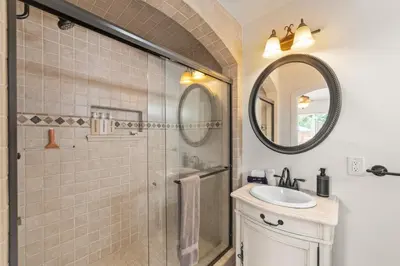 a bathroom with a shower and a sink and a mirror at Casa Sur in Chula Vista