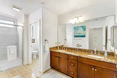 a bathroom with two sinks and a shower at Seacliff Retreat in Oceanside