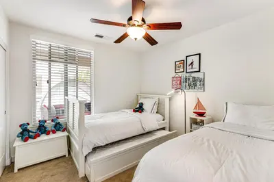 a bedroom with two beds and a ceiling fan at Seacliff Retreat in Oceanside