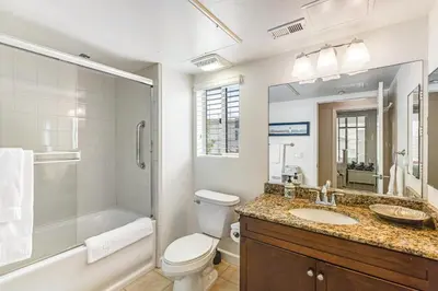 a bathroom with a toilet sink and a shower at Seacliff Retreat in Oceanside