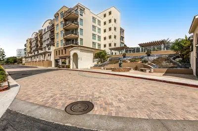 a cobblestone street with a building and a drain at Seacliff Retreat in Oceanside