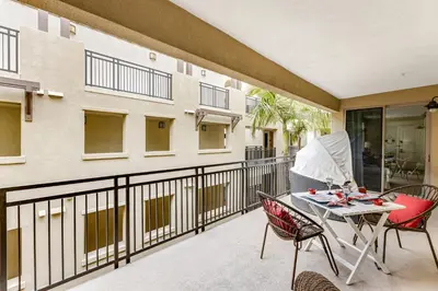 a patio with a table and chairs on a balcony at Seacliff Retreat in Oceanside