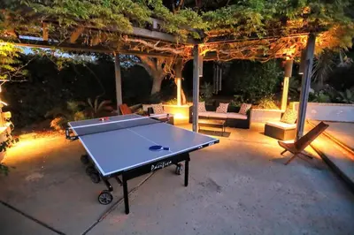 a ping pong table in a backyard at night at Luxury Modern Chateau near wineries & beaches in Fallbrook