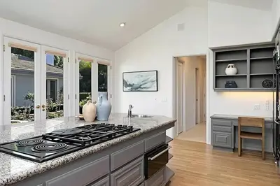 a kitchen with a stove and a counter top at Luxury Modern Chateau near wineries & beaches in Fallbrook