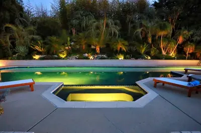 a swimming pool with two benches and a table and a pool at Luxury Modern Chateau near wineries & beaches in Fallbrook