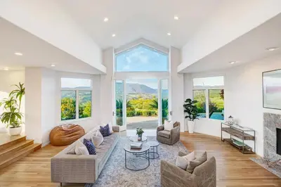 a living room with a couch and a fireplace at Luxury Modern Chateau near wineries & beaches in Fallbrook