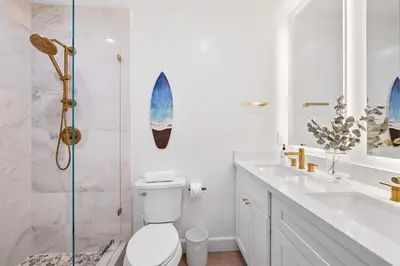 a bathroom with a shower and a toilet and a sink at Hideaway Zen in San Diego