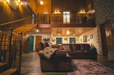 a living room with a couch and a staircase at Tucker Peak Lodge in Julian
