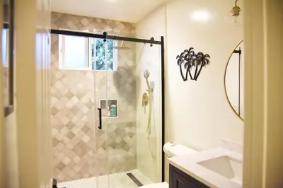 a bathroom with a shower and a sink at Mile to Beach! Fully Fenced Private SoCal Cottage in Oceanside