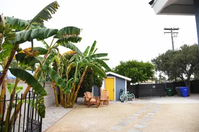 a backyard with a table and chairs and a fence at Mile to Beach! Fully Fenced Private SoCal Cottage in Oceanside