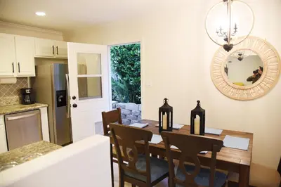a kitchen and dining room with a table and chairs at Mile to Beach! Fully Fenced Private SoCal Cottage in Oceanside