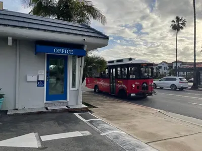 a red bus is parked next to a building at Calafia Inn San Clemente Newly renovated in San Clemente