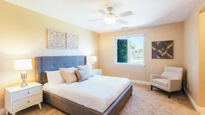 a bedroom with a bed and a window and a chair at Secluded Estate Exclusive Views of Wine Country Private Home Theater Twilight Vines by AvantStay in Sage