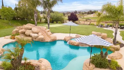 a swimming pool with two umbrellas in a resort at Secluded Estate Exclusive Views of Wine Country Private Home Theater Twilight Vines by AvantStay in Sage