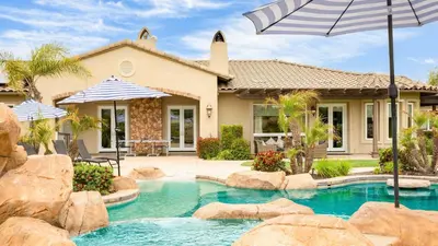 a house with a swimming pool with an umbrella at Secluded Estate Exclusive Views of Wine Country Private Home Theater Twilight Vines by AvantStay in Sage