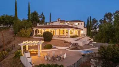 a house with a table and chairs in front of it at Wine Country Villa • Large Rooftop Terrace w Views Game Room Via del Sur in Temecula