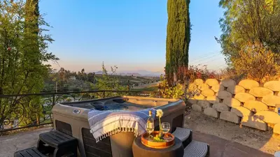 a hot tub sitting on top of a balcony at Wine Country Villa • Large Rooftop Terrace w Views Game Room Via del Sur in Temecula