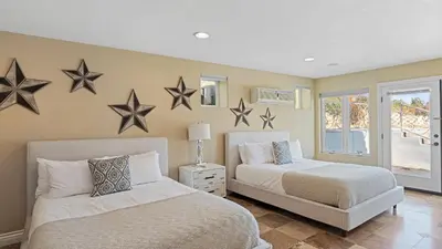 two beds in a bedroom with stars on the wall at Wine Country Villa • Large Rooftop Terrace w Views Game Room Via del Sur in Temecula