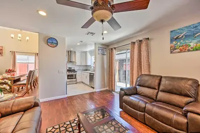 a living room with a couch and a ceiling fan at Karaoke Fun, Hot Tub and Patio! San Diego Sanctuary in San Diego