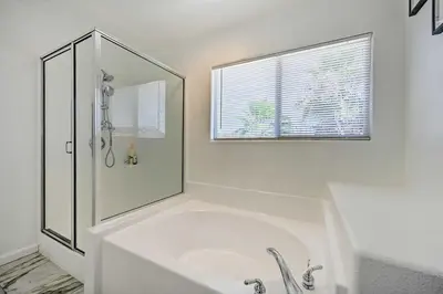 a white bathroom with a tub and a shower at Karaoke Fun, Hot Tub and Patio! San Diego Sanctuary in San Diego