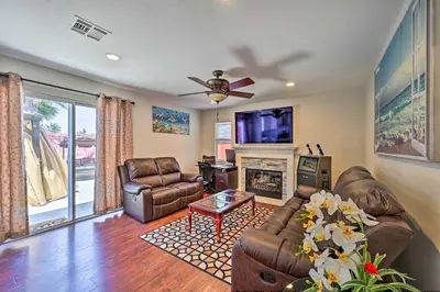 a living room with leather furniture and a fireplace at Karaoke Fun, Hot Tub and Patio! San Diego Sanctuary in San Diego