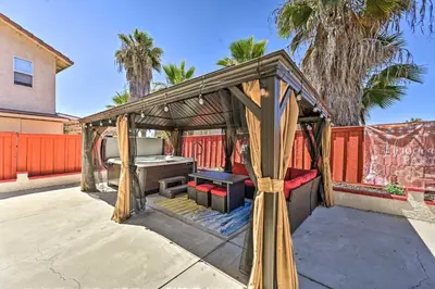 a gazebo with a bed and a table at Karaoke Fun, Hot Tub and Patio! San Diego Sanctuary in San Diego