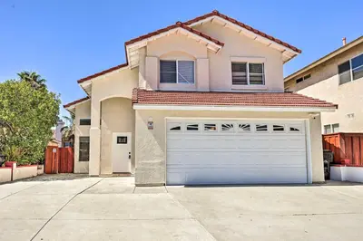 a house with a garage door in a driveway at Karaoke Fun, Hot Tub and Patio! San Diego Sanctuary in San Diego