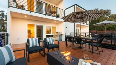 a patio with a table and chairs and a fireplace at Avalon 2 Unit Buyout II IV by AvantStay Mins to Gaslamp Patio w BQQ in San Diego