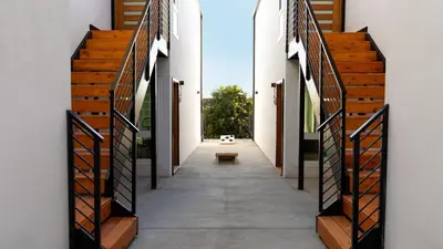 a corridor in a house with wooden stairs at Avalon 2 Unit Buyout II IV by AvantStay Mins to Gaslamp Patio w BQQ in San Diego