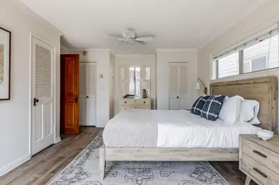 a bedroom with a bed and a ceiling fan at Bay View I by AvantStay Stylish Mission Beach Home on the Sand in San Diego