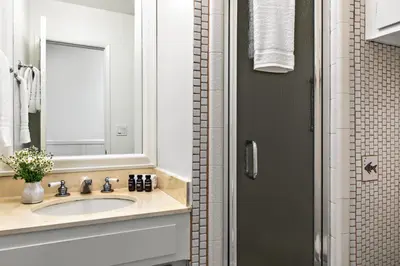 a bathroom with a sink and a mirror at Bay View 3 by AvantStay Stunning Home on the Beach In Mission Beach in San Diego