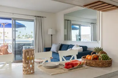 a living room with a table with fruit on it at Bay View 3 by AvantStay Stunning Home on the Beach In Mission Beach in San Diego