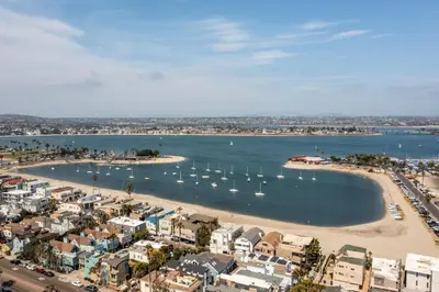 an aerial view of a beach with boats in the water at Bay View 3 by AvantStay Stunning Home on the Beach In Mission Beach in San Diego