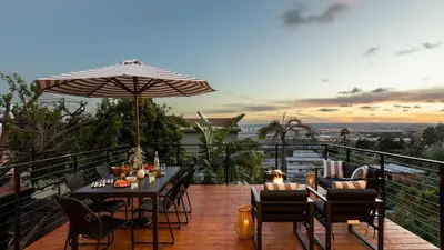 a patio with a table and chairs and an umbrella at Avalon Buyout by AvantStay Mins to Gaslamp Rooftop w BBQ Patio in San Diego