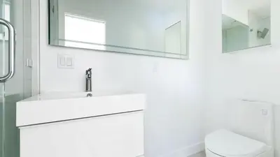a white bathroom with a sink and a mirror at Avalon 2 Unit Buyout I III AvantStay Mins to GaslampBeautiful Deck w BBQ in San Diego