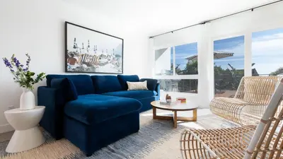 a living room with a blue couch and a chair at Avalon 2 Unit Buyout I III AvantStay Mins to GaslampBeautiful Deck w BBQ in San Diego