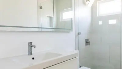 a white bathroom with a sink and a shower at Avalon 2 Unit Buyout I III AvantStay Mins to GaslampBeautiful Deck w BBQ in San Diego