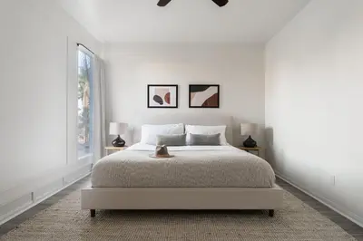 a white bedroom with a bed and a window at Balboa I by AvantStay - Stylish Condo Balboa Park Adjacent w Views in San Diego