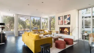 a living room with a yellow couch and a fireplace at Balboa Buyout by AvantStay - Condo w Views in DT San Diego in San Diego