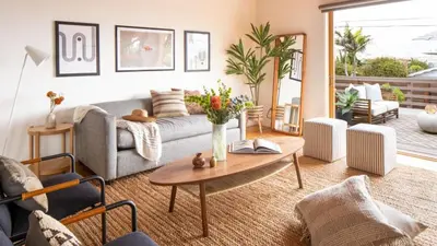 a living room with a couch and a table at Camden by AvantStay 5mins to the Beach Elevated Home w Pacific Ocean Views in Encinitas