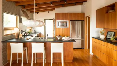 a kitchen with a large island with bar stools at Camden by AvantStay 5mins to the Beach Elevated Home w Pacific Ocean Views in Encinitas