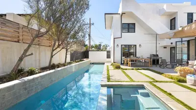 a swimming pool in the backyard of a house at Vista Del Mar by AvantStay Stunning Spanish Inspired Home w Pool Hot Tub Rooftop Patio in San Diego