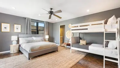 a bedroom with two bunk beds and a ceiling fan at Vista Del Mar by AvantStay Stunning Spanish Inspired Home w Pool Hot Tub Rooftop Patio in San Diego